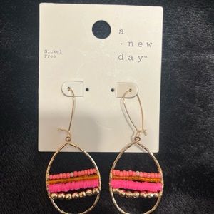 A New Day earrings. Gold colored with pink and orange beading.
